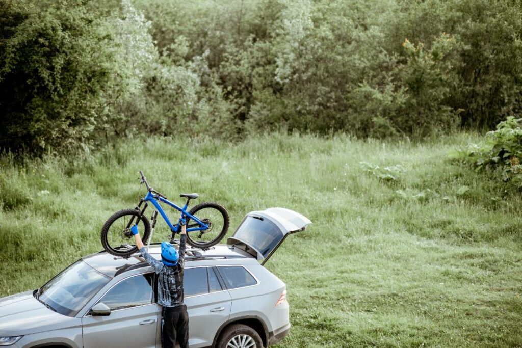 cyclist-with-bicycle-and-car-outdoors-2023-11-27-05-09-03-utc