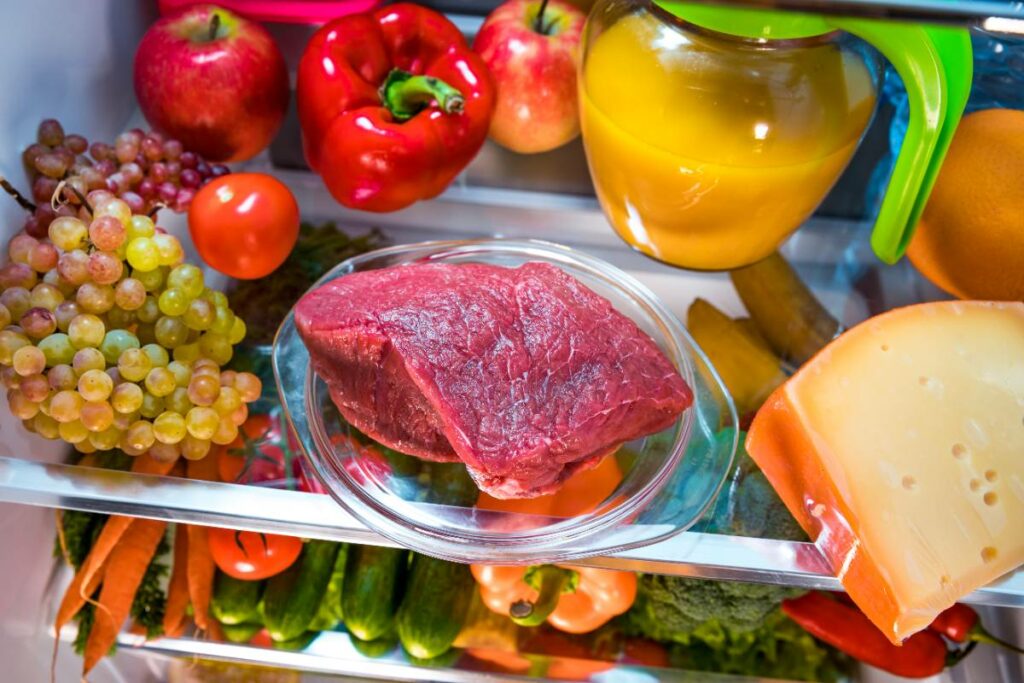 fresh-raw-meat-on-a-shelf-open-refrigerator-2023-11-27-05-29-02-utc