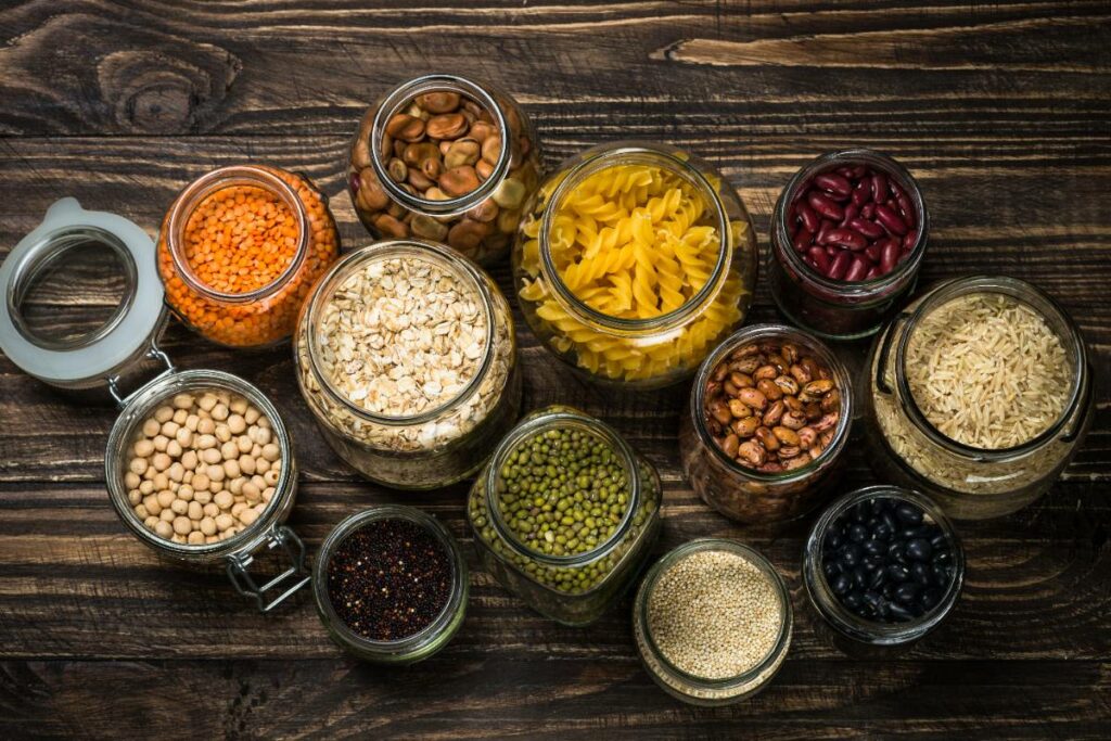 cereals-legumes-and-beans-in-glass-jars-on-dark-2023-11-27-05-12-02-utc